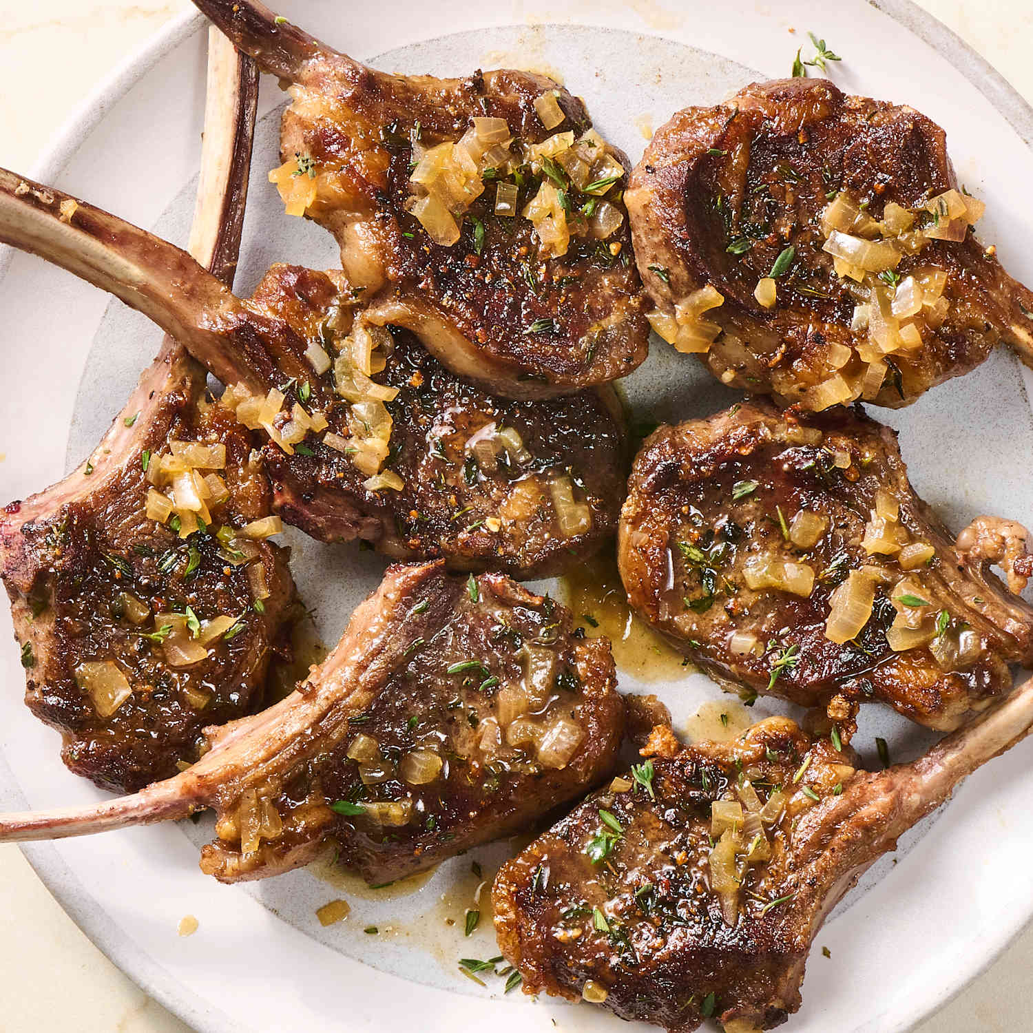 Grilled lamb chops seasoned with house spices and served with sides at Preva Kitchen Redford MI